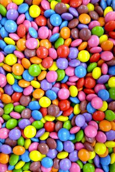 many different colored candies are scattered together