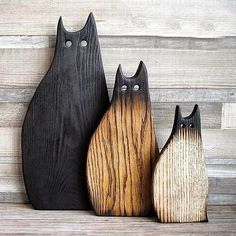 three wooden cats sitting next to each other