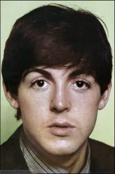 an old photo of a young man wearing a suit and tie with his eyes wide open