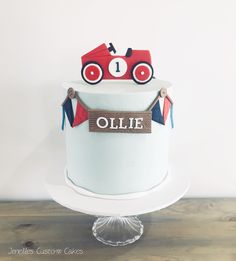 there is a cake with a name on it and a train decoration in the middle