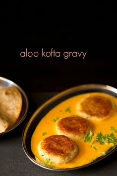 some food is sitting in a pan on a black surface with the words aloo kofta gravy