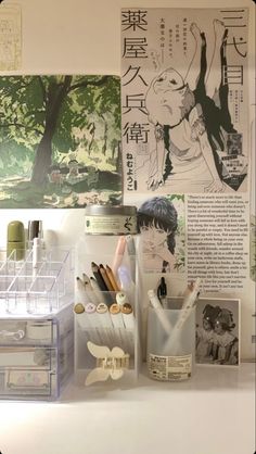 an assortment of office supplies on display in a room with japanese writing and pictures behind them