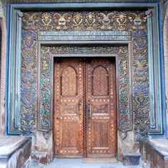 an ornate wooden door with intricate carvings on it