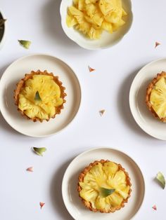 pineapple tarts on small white plates with confetti scattered around the edges