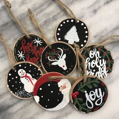 six decorated christmas cookies sitting on top of a marble counter