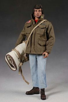 a man in an army uniform holding a large object