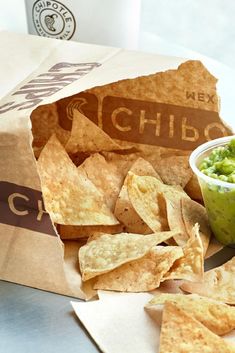 chips and guacamole in a paper bag