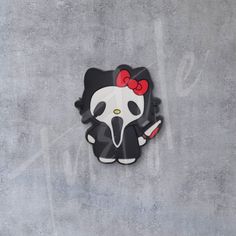 a hello kitty clock with a red bow on it's head and a knife in its hand