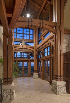 the inside of a large building with wooden beams and windows on each side of it