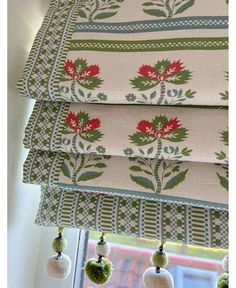 the roman blinds are decorated with poinsettis