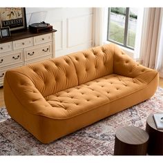 an orange couch sitting on top of a rug