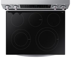 an electric stove with four burners on the front, and two oven doors open