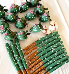 a table topped with lots of green and white strawberries covered in sprinkles