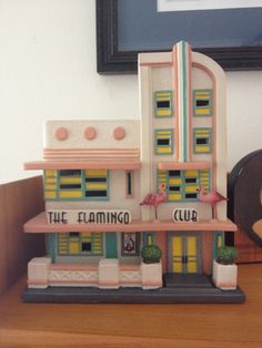 the flamingo club is on display in front of a framed photo and other items