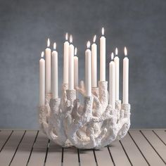 a group of white candles sitting on top of a table