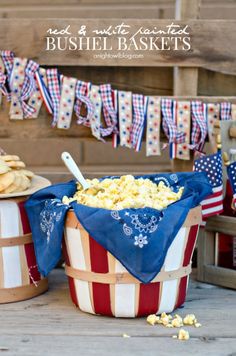 some buckets filled with popcorn and bunnies are on the table for fourth of july party ideas