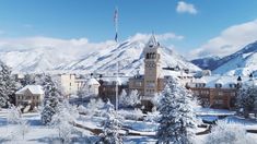 a large building surrounded by snow covered trees in the middle of a mountain range with a flagpole on top