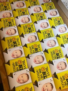 there are many pamphlets with pictures of baby heads on them, all in yellow and black