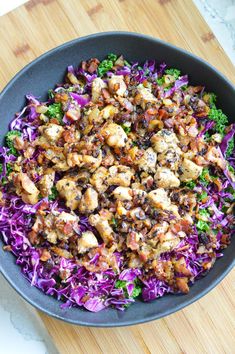 a bowl filled with chicken and purple cabbage