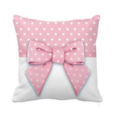 a pink and white pillow with a bow on it