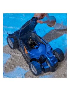 someone is playing with a toy car on the carpet in front of a blue blanket