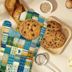 an oven mitt sitting on top of a counter next to cookies and other baking supplies