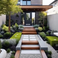 a modern house with wooden steps leading up to the front door and grass area on both sides