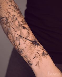 a person with a flower tattoo on their arm