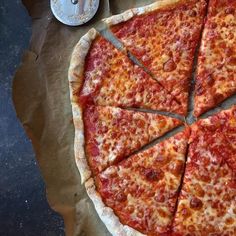 the pizza is cut into four slices and ready to be eaten with one slice missing