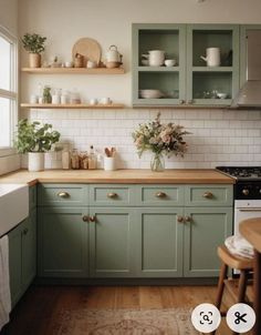 a kitchen with green cabinets and wooden floors