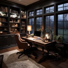 a home office with large windows and lots of bookshelves