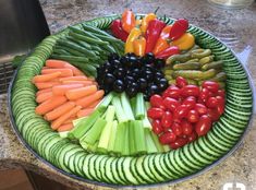 a platter filled with vegetables on top of a kitchen counter