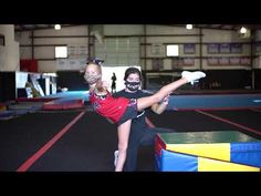 two girls doing tricks on an indoor trampoline