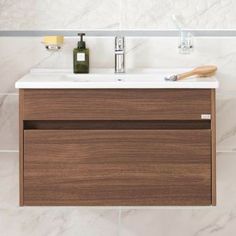 a bathroom sink with a wooden cabinet underneath it