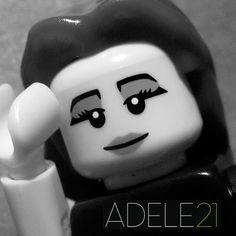 a black and white photo of a lego figure with the words adele 21 on it