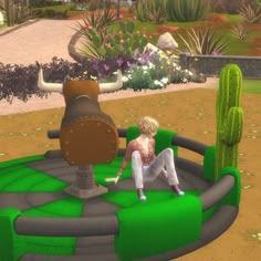 a woman sitting on top of a green and black inflatable structure next to a cactus