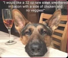 a german shepherd dog sitting at a table with a glass of wine in front of him