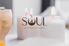 three candles sitting on top of a table with the word soul in front of them