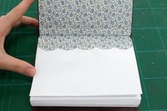 a person is making a folded piece of paper