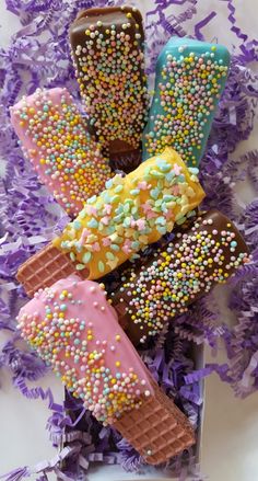 there are five ice creams with sprinkles on them