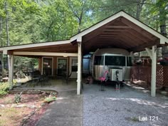 an rv is parked under a covered patio