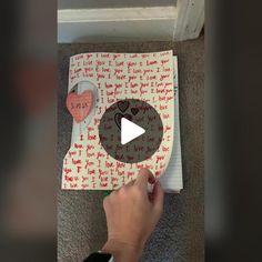 someone is making a valentine's day card out of paper