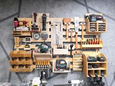 a workbench with many tools on it and some shelves filled with different items