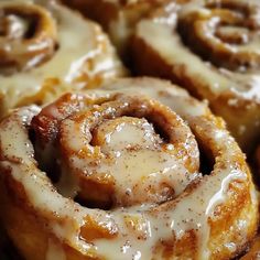 several cinnamon rolls with icing on top of them