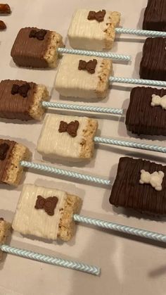 chocolate and marshmallow treats are arranged on sticks