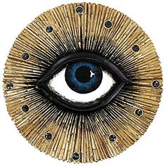 an eye made out of gold and blue beads with black dots around the iris's eyes