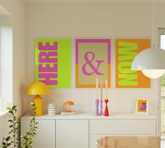 a living room filled with furniture and paintings on the wall above it's table