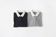 two sweater vests with polka dots on the collar and one has a bow tie