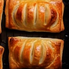 four loaves of bread sitting on top of a grill