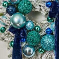 a christmas wreath with blue and green ornaments